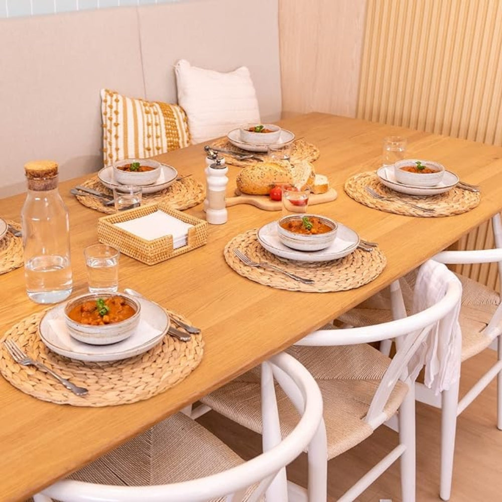 Natural woven placemats arranged for dining table sourcing